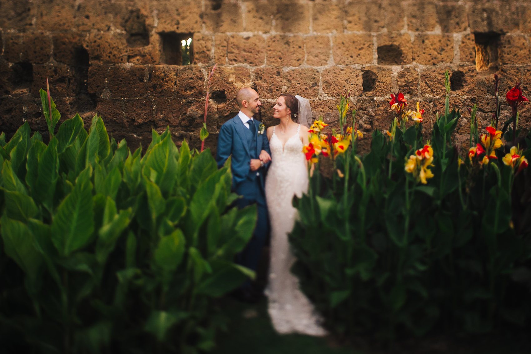 Couple by flowers in warm Italian evening light